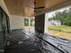 Covered back porch area with two ceiling fans and view of the unfinished yard at 3405 Makers Circle, Raleigh, NC 27612