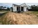 Backyard of a two-story home with large columns supporting a covered porch at 3405 Makers Circle, Raleigh, NC 27612