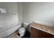 Bright bathroom with a vanity, toilet, and tub with fresh white tiles at 3405 Makers Circle, Raleigh, NC 27612