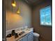 Bathroom with a new vanity, framed mirror, new toilet, and light fixture at 3405 Makers Circle, Raleigh, NC 27612