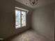 Cozy bedroom featuring a large window with natural light and a modern ceiling fixture at 3405 Makers Circle, Raleigh, NC 27612