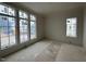 Bright bedroom featuring lots of big windows and unfinished flooring that awaits customization at 3405 Makers Circle, Raleigh, NC 27612