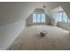 Expansive bonus room with large windows and sloped ceilings, offering versatile living and entertainment space at 3405 Makers Circle, Raleigh, NC 27612