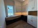 This butler's pantry has upper cabinets and a window at 3405 Makers Circle, Raleigh, NC 27612