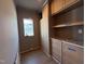 Closet with custom shelves, cabinets, drawers, and a window at 3405 Makers Circle, Raleigh, NC 27612