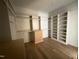 Walk-in closet with custom shelving and hardwood floors at 3405 Makers Circle, Raleigh, NC 27612