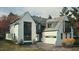 New construction two story home with attached garage and black trim and window frames at 3405 Makers Circle, Raleigh, NC 27612