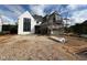 New construction home showing modern design elements and under-construction exterior finishes and professional scaffolding at 3405 Makers Circle, Raleigh, NC 27612