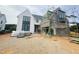 Two story home with white stucco and black trim and window frames under construction at 3405 Makers Circle, Raleigh, NC 27612