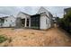 Under-construction home featuring white siding and black framed windows on a cloudy day at 3405 Makers Circle, Raleigh, NC 27612