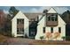 Two-story home featuring a white stucco facade, gray shingles, black trim windows, and professionally landscaped front yard at 3405 Makers Circle, Raleigh, NC 27612