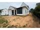 View of the home's exterior shows white siding and dark window trim at 3405 Makers Circle, Raleigh, NC 27612