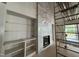 Modern fireplace with light marble tiling and wooden shelves with a ladder nearby at 3405 Makers Circle, Raleigh, NC 27612