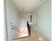 Hallway features a staircase with iron handrail, and stylish pendant lighting at 3405 Makers Circle, Raleigh, NC 27612