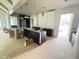 Open-concept kitchen with dark cabinetry and modern light fixtures at 3405 Makers Circle, Raleigh, NC 27612