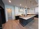 This kitchen has stainless appliances, black cabinets, and a kitchen island at 3405 Makers Circle, Raleigh, NC 27612