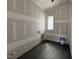Unfinished laundry room with dark tile floors features a small window at 3405 Makers Circle, Raleigh, NC 27612