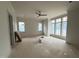 Bright living room with large windows and a modern ceiling fan at 3405 Makers Circle, Raleigh, NC 27612