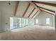 Spacious living room featuring vaulted ceiling with wooden beams and large sliding glass doors at 3405 Makers Circle, Raleigh, NC 27612