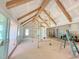 Living area with vaulted ceilings and wood beams features a sliding glass door leading to a porch at 3405 Makers Circle, Raleigh, NC 27612
