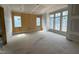 Unfinished room showcases wood paneled wall, multiple windows, and unfinished floors offering customization at 3405 Makers Circle, Raleigh, NC 27612