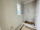 New tiled shower featuring a bright window, combining functionality with a modern aesthetic at 3405 Makers Circle, Raleigh, NC 27612