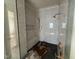 New shower with a glass door, tile surround, built-in bench, and rainfall shower head at 3405 Makers Circle, Raleigh, NC 27612