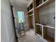 Unfinished walk-in closet boasts built in shelving and a window at 3405 Makers Circle, Raleigh, NC 27612