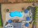 Aerial view of a backyard featuring a pool, patio, outdoor kitchen, and lush landscaping at 3548 Willow Green Dr, Apex, NC 27502