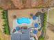 Aerial view of a spacious backyard featuring a pool, patio, outdoor kitchen, and landscaped areas at 3548 Willow Green Dr, Apex, NC 27502