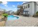 Relaxing backyard retreat featuring a sparkling pool and comfortable outdoor dining area at 3548 Willow Green Dr, Apex, NC 27502