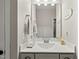 Bright bathroom with white vanity, large mirror and decorative items at 3548 Willow Green Dr, Apex, NC 27502
