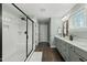 Bright bathroom features a glass enclosed shower, double vanity, and wood-look tile floors at 3548 Willow Green Dr, Apex, NC 27502
