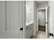 Hallway leading to bathroom featuring white vanity and modern fixtures at 3548 Willow Green Dr, Apex, NC 27502
