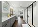 Bathroom boasts a glass enclosed shower, double vanity, and view into the bedroom at 3548 Willow Green Dr, Apex, NC 27502