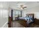 Cozy bedroom with a ceiling fan, window, and wood-look flooring at 3548 Willow Green Dr, Apex, NC 27502
