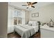 Calm bedroom with a large window, neutral color palette, and a decorative welcome sign at 3548 Willow Green Dr, Apex, NC 27502