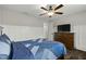 Comfortable bedroom featuring a ceiling fan, dresser, and wood-look flooring at 3548 Willow Green Dr, Apex, NC 27502