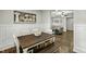 Dining room with wood floors, large artwork and wainscoting, flows into the living room at 3548 Willow Green Dr, Apex, NC 27502