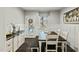 Bright dining room with wainscoting, wood floors, server, and glass door to the back yard at 3548 Willow Green Dr, Apex, NC 27502