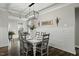 Farmhouse style dining room featuring a decorative chandelier, wainscoting, and bright natural light at 3548 Willow Green Dr, Apex, NC 27502