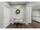 Cozy entryway with a bench, decorative wreath, and 'Gathering' sign, creating a welcoming atmosphere at 3548 Willow Green Dr, Apex, NC 27502