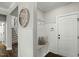 Inviting entryway with built-in bench, coat hooks, and stylish decor at 3548 Willow Green Dr, Apex, NC 27502