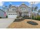 Charming two-story home with a well-manicured lawn and a two-car garage at 3548 Willow Green Dr, Apex, NC 27502