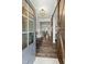 Inviting foyer with hardwood floors, a bench, barn door and an open view into the dining room at 3548 Willow Green Dr, Apex, NC 27502