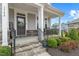 Charming front porch with stone steps, black railings, and a 'Welcome' sign at 3548 Willow Green Dr, Apex, NC 27502