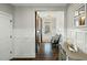 Hallway with barn doors leading to the front entry, wooden floors, and white wainscoting at 3548 Willow Green Dr, Apex, NC 27502