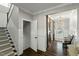 Hallway with stairs and a view of the front entry with decorative barn doors and coat closet at 3548 Willow Green Dr, Apex, NC 27502