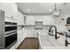 Modern kitchen with stainless steel appliances and an island with a farm sink at 3548 Willow Green Dr, Apex, NC 27502
