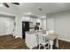 Bright kitchen with white cabinets, stainless appliances, island with seating, and wood floors at 3548 Willow Green Dr, Apex, NC 27502